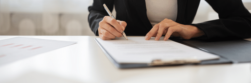 person signing a document as a co-signer on a loan for financial responsibility