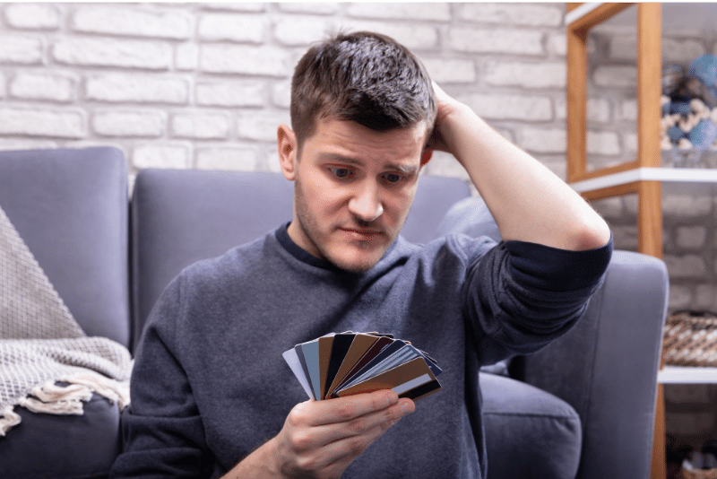 A person looking at their credit card debt with a worried expression