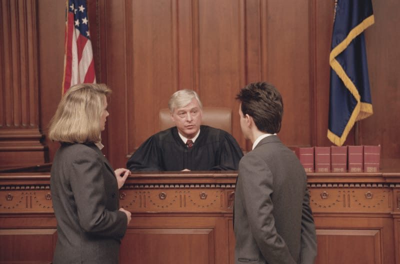 A woman talking to a judge about a wrongful eviction